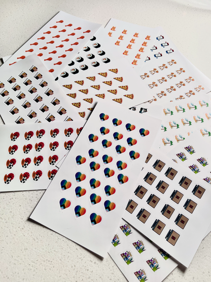 Sheets of small stickers with various designs on a light surface